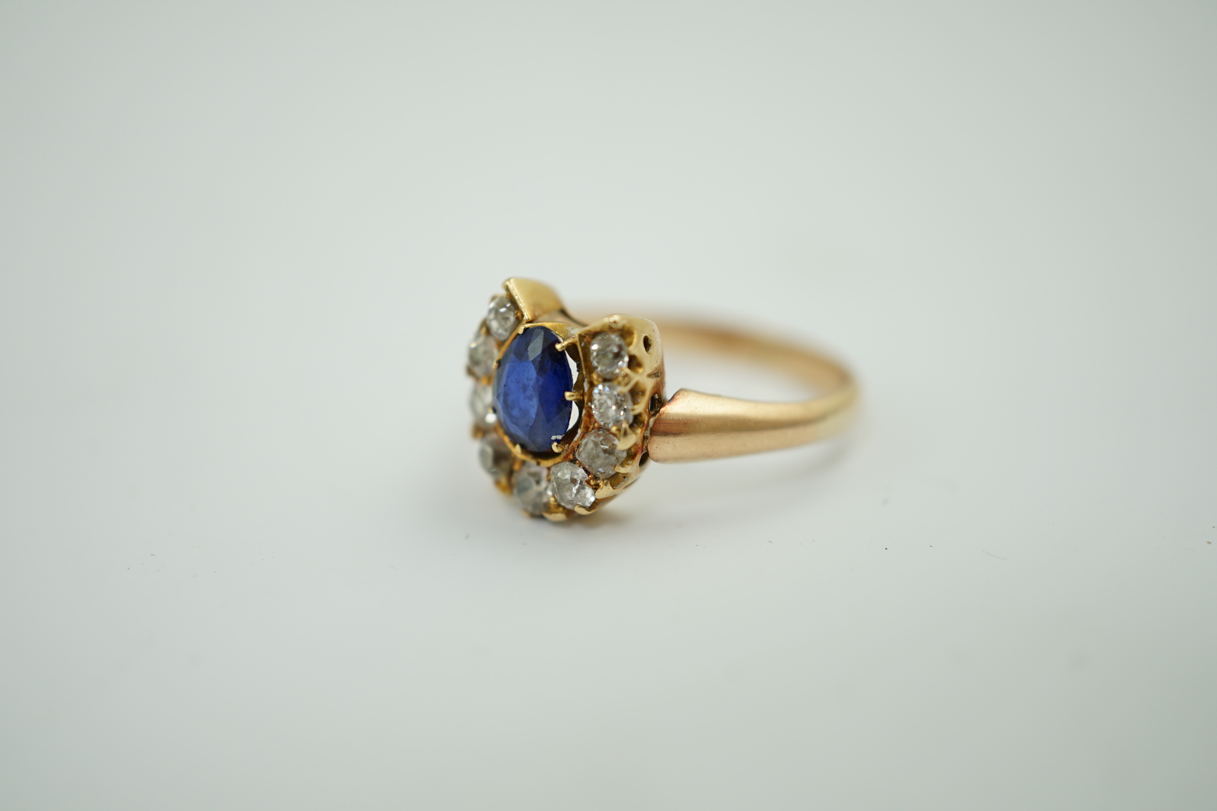 An early to mid 20th century gold, sapphire and diamond set horseshoe cluster ring